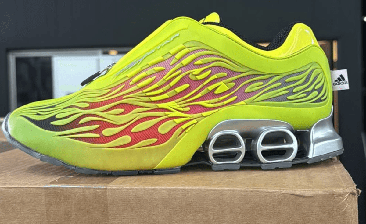 Hellstar x adidas Megaride S2 in neon yellow with red, pink, and purple gradient mesh visible through flame cutout details and metallic silver outsole