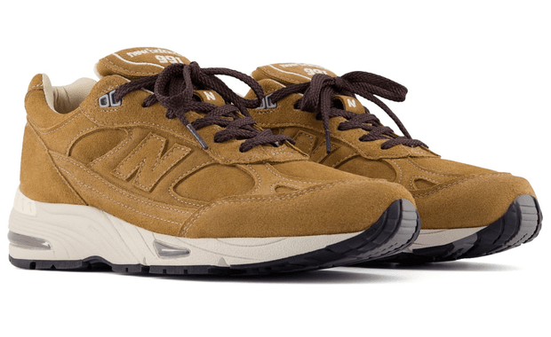 New Balance 991v1 Made in UK in tan suede, showcasing premium suede upper construction and asymmetrical lacing
