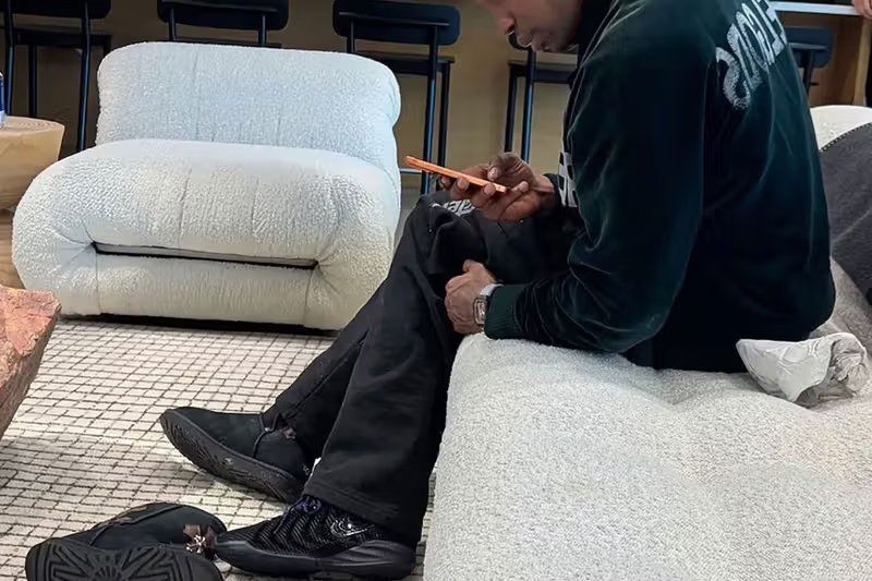 Travis Scott wearing unreleased Nike Caitlin 1 all-black sample with raised CC mesh siding and stacked inset Swoosh design