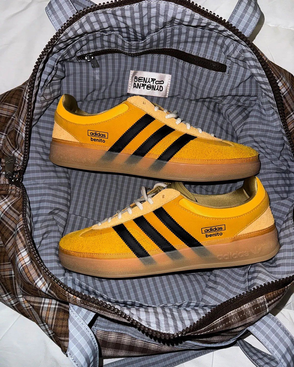Bad Bunny x adidas Gazelle Indoor in Solar Gold with black stripes, showing canvas foxing and offset T-toe construction