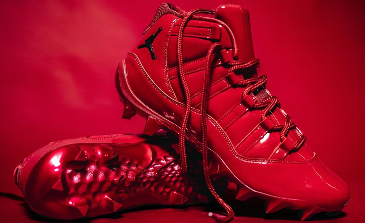 Air Jordan 11 Oklahoma PE in monochrome Sooner red patent leather with metallic red spikes and white OU logo on tongue