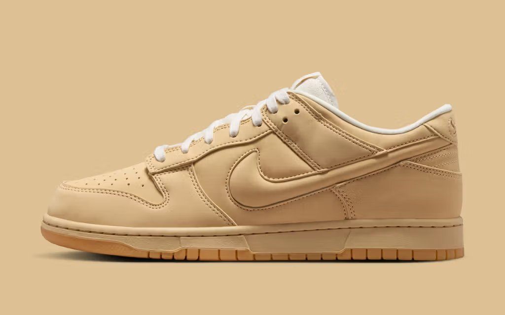 Nike Dunk Low PRM Sesame with exaggerated oversized Swoosh design, lateral view showing bulbous Swoosh extension