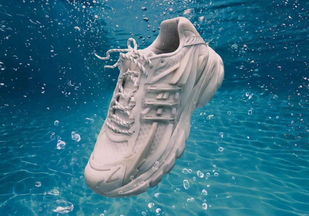 Pharrell x adidas Adistar Jellyfish Triple White featuring all-white mesh upper, molded cage overlay, and curved midsole