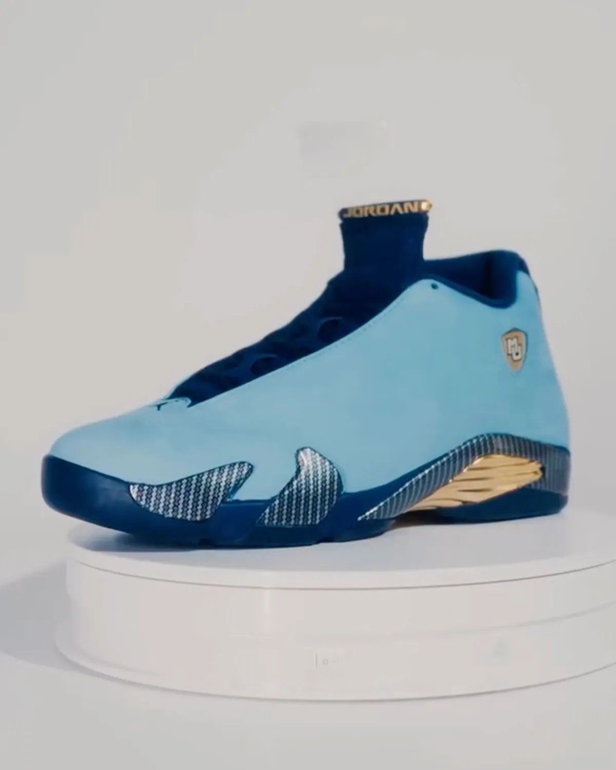 Marquette Air Jordan 14 PE in monochromatic suede with gold midsole vents and carbon fiber overlays