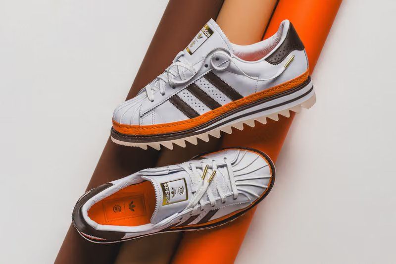 adidas Originals x CLOT Superstar "Unity Orange" sneaker featuring vibrant orange leather upper with white Three Stripes and gold lace tips