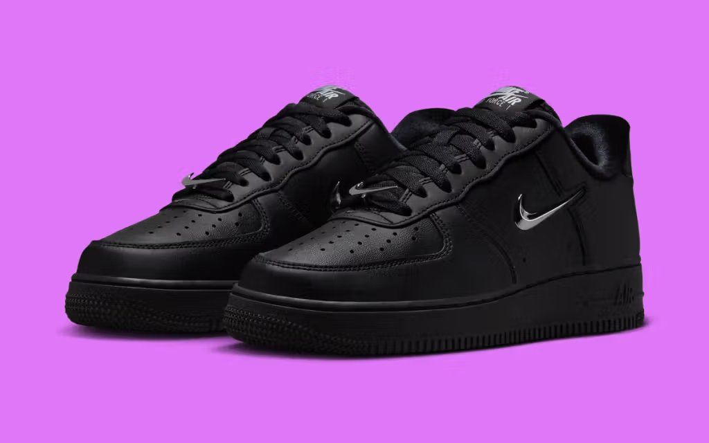Nike Air Force 1 Low women's sneaker with metallic silver Swoosh detailing on neutral base