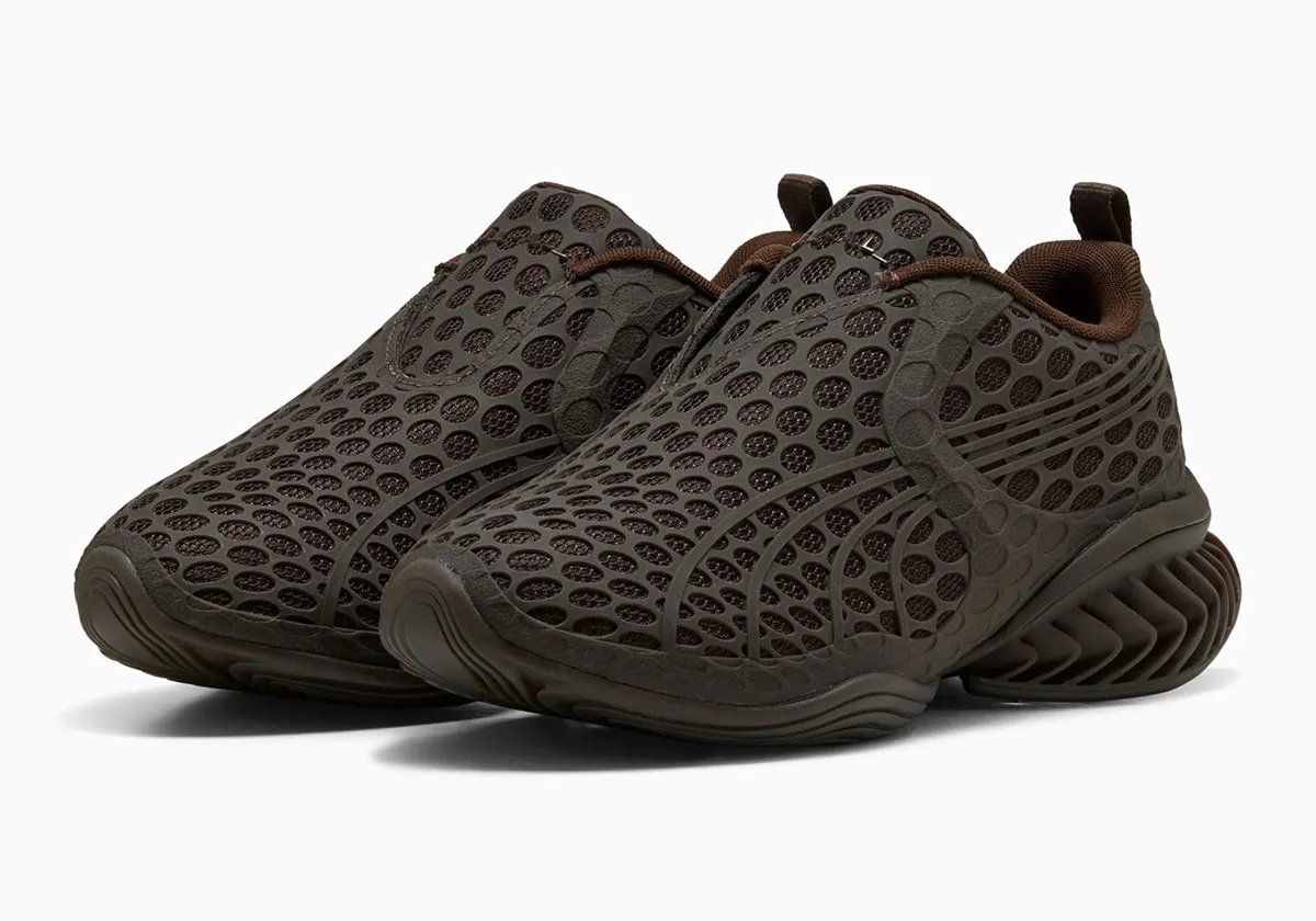 PUMA x _J.L-A.L_ Cell GEO-1 with geometric pocked cutouts across upper, lateral cage, and tongue in rich brown colorway