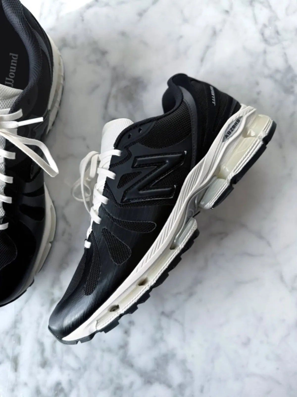 JJJJound x New Balance 1890 collaboration sneaker in black with aged off-white midsole and silver ABZORB detailing