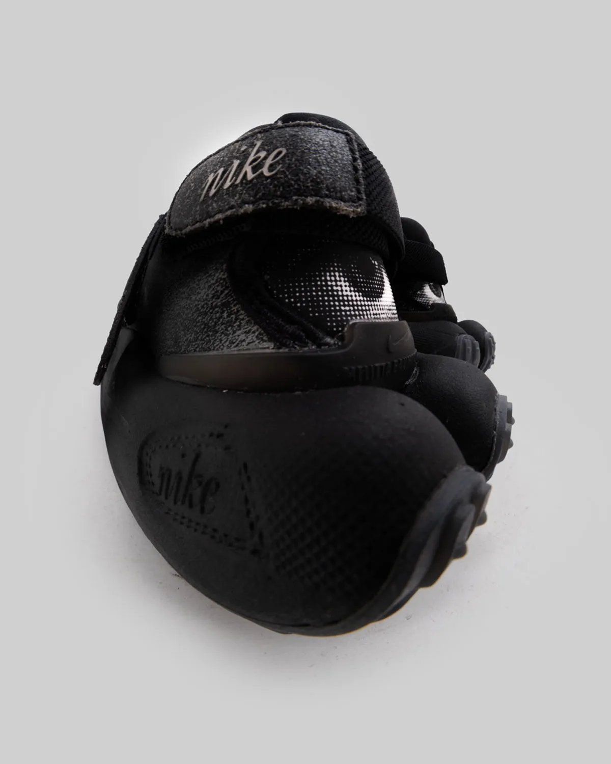 Melitta Baumeister x Nike Rift Rocker in Black/Black/White, featuring oversized waffle sole and optical graphics