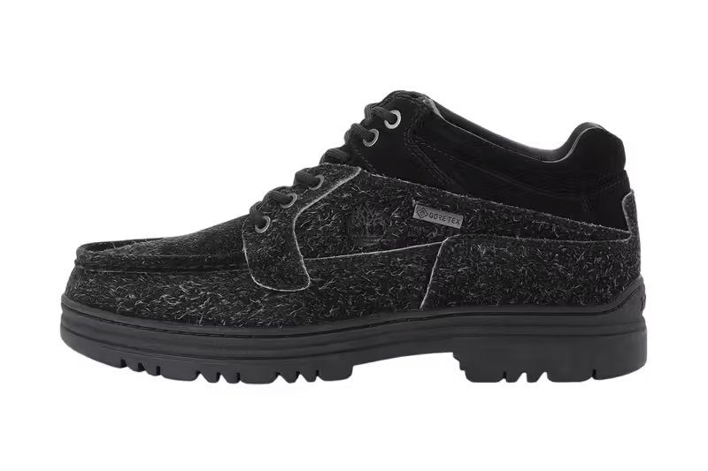 Timberland Heritage GORE-TEX Moc Toe Mid in black suede, three-quarter view showing moc toe profile and mid-top silhouette