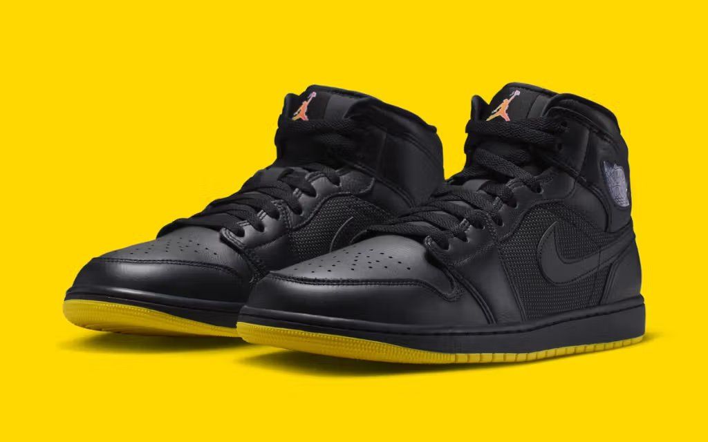 Air Jordan 1 Mid in Gotham colorway with dark charcoal and black tonal upper and graphic comic book-inspired detailing