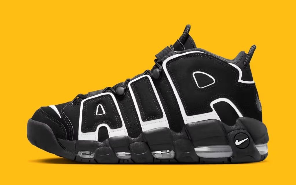 Nike Air More Uptempo in White and Black colorway, front three-quarter view showing oversized swoosh and ankle collar
