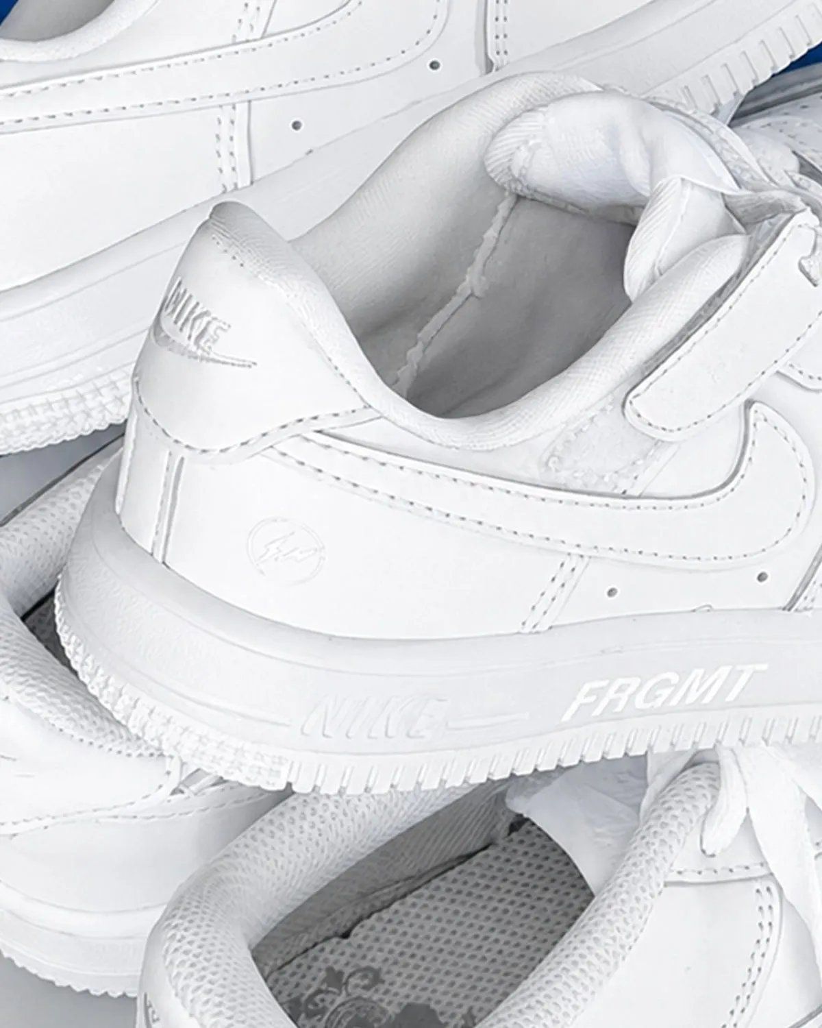 FRGMTmini x Nike Air Force 1 Low EasyOn in Triple White with Fragment lightning bolt branding on lateral heel