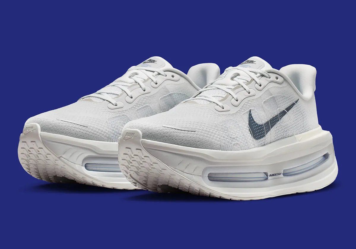 Nike Vomero Premium in Off White colorway with Dark Obsidian Swoosh, lateral view showing 55mm cushioning stack