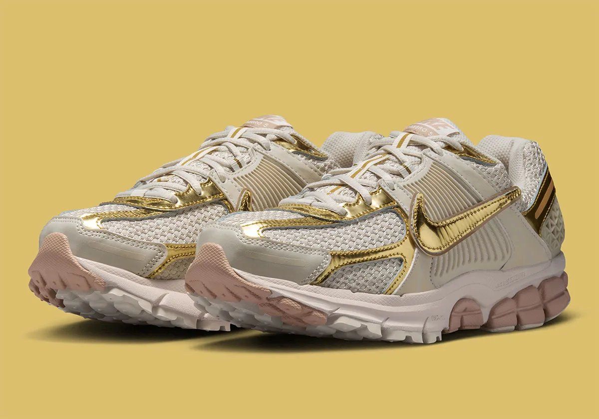 Nike Zoom Vomero 5 Metallic Gold colorway with rosy Swoosh detailing and metallic accents on upper