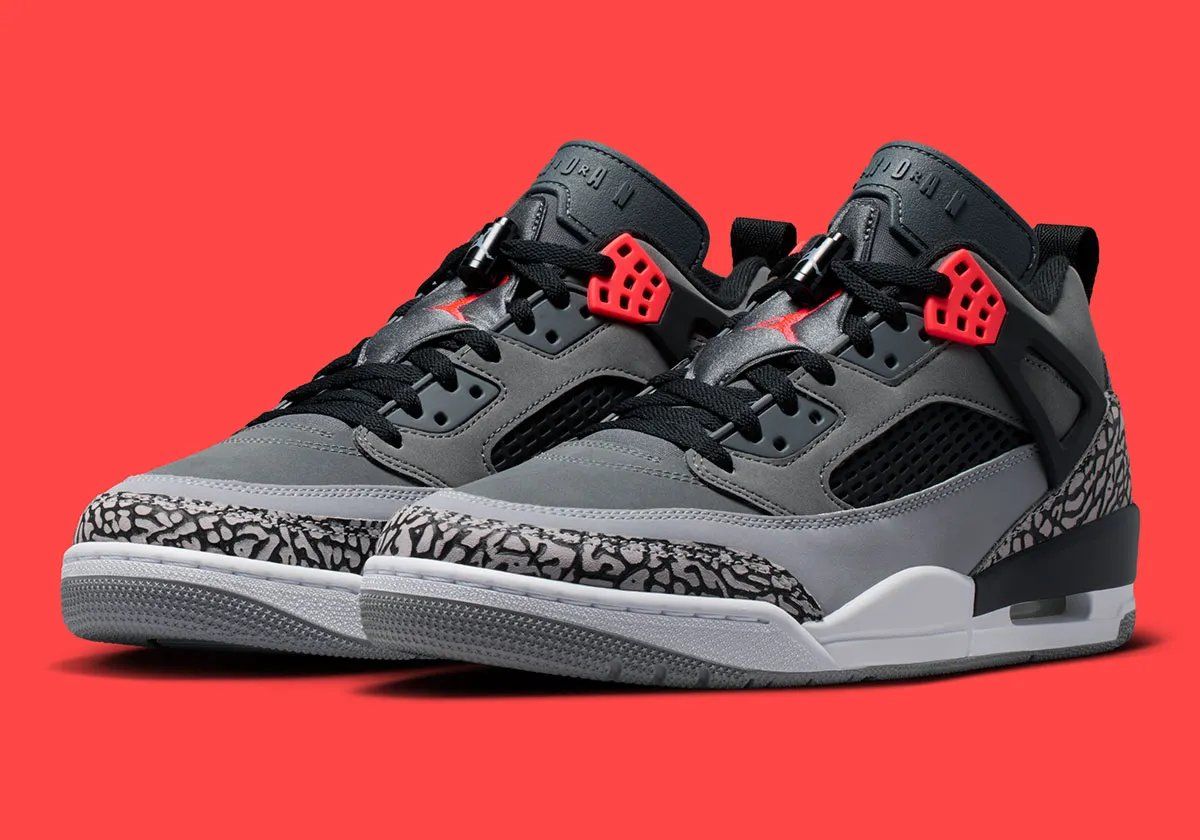 Jordan Spiz'ike Low in Infrared colorway, side profile view showing mixed-material upper construction and distinctive lace toggle detail