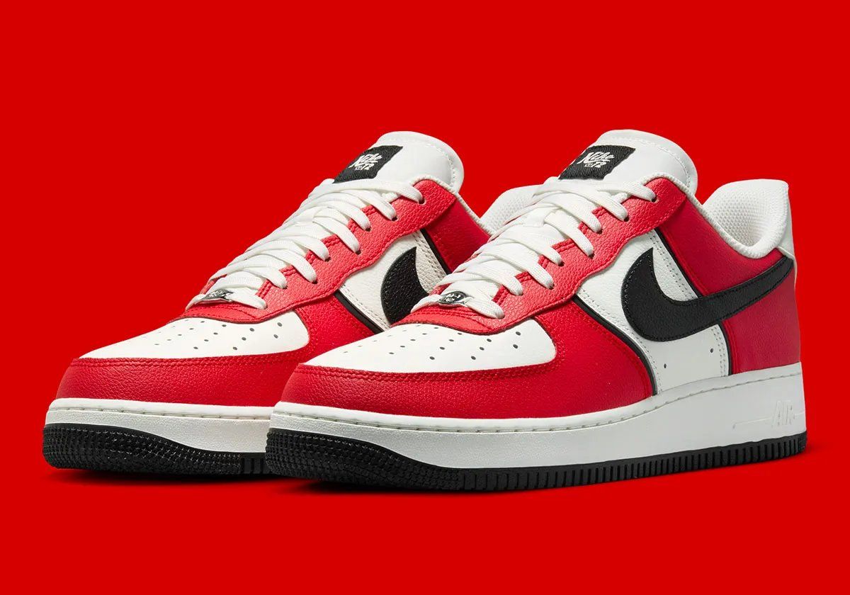 Nike Air Force 1 Low in University Red and black with diamond heel branding and Sail quarter panel