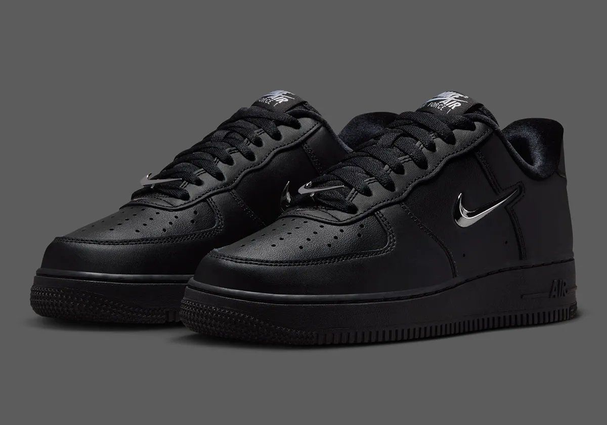 Nike Air Force 1 Low in black leather with chrome silver Swoosh detail, side view