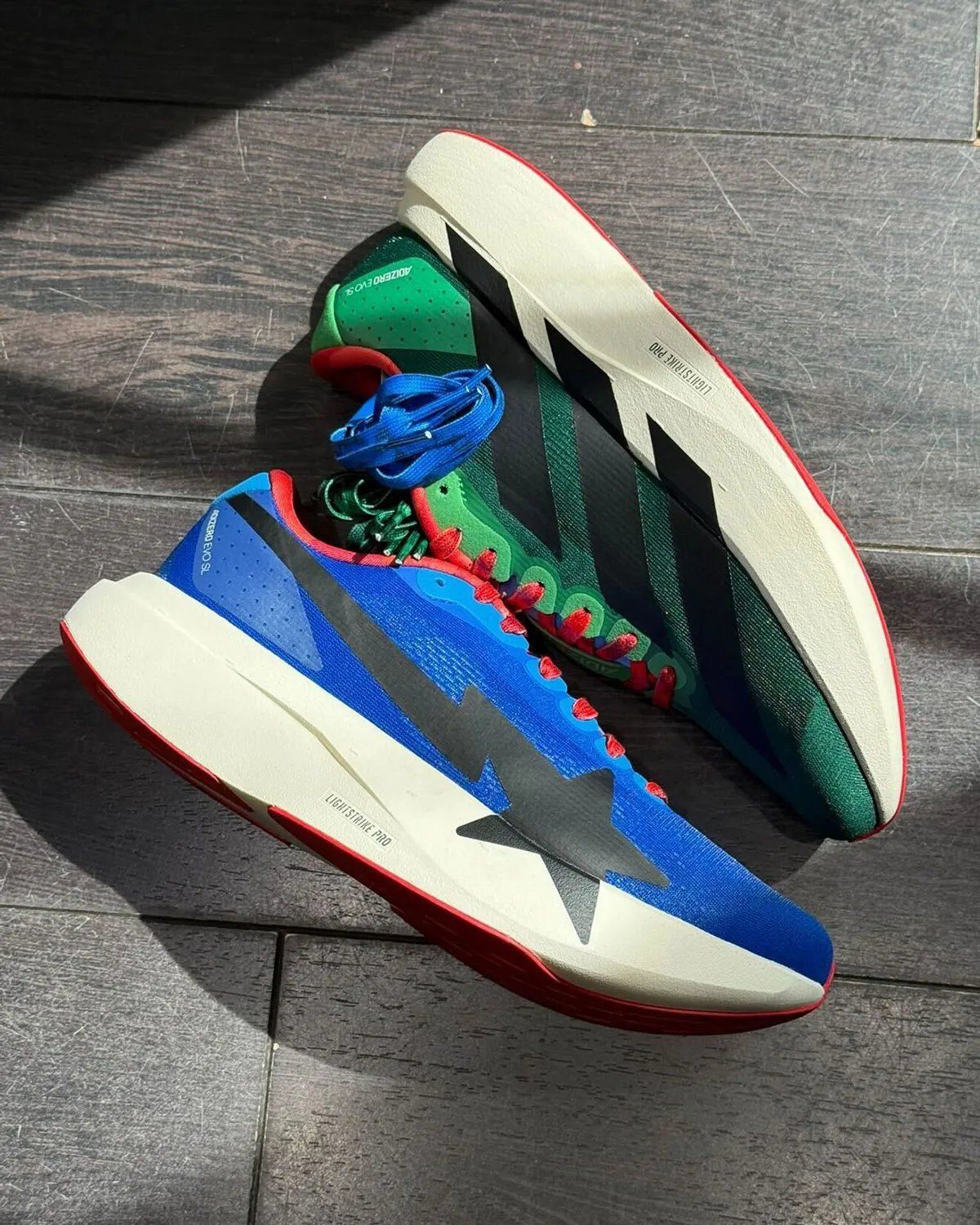 Bape x adidas Adizero EVO SL mismatched colorway featuring asymmetrical blue and green construction with inverted branding