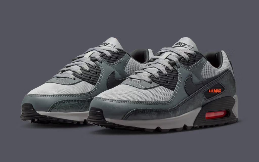 Nike Air Max 90 Black and Hyper Crimson colorway, featuring black upper with crimson accents and visible Air Max unit