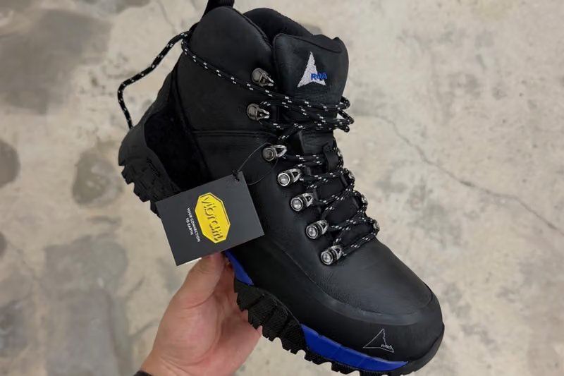 ROA x fragment design Andreas Boot side profile showing leather upper, Vibram sole, and metallic lace hooks