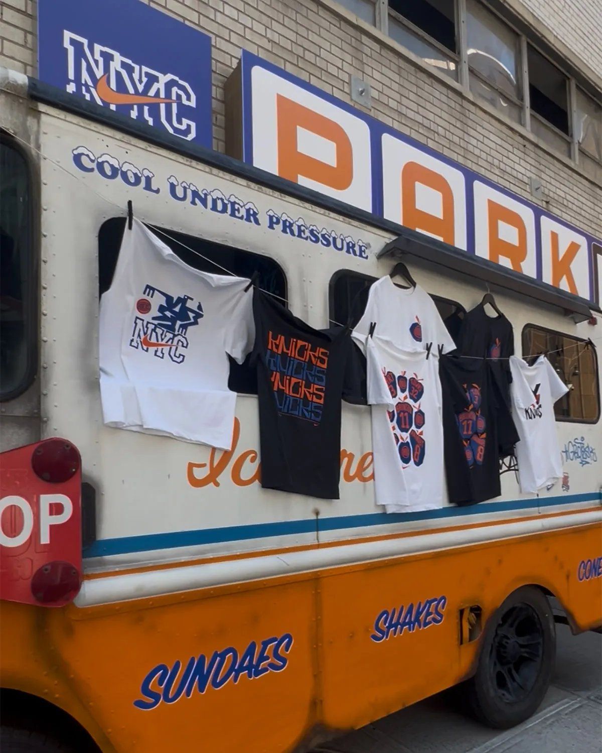 Nike Park N Shop pop-up activation inside Park N Lock garage near Madison Square Garden, featuring custom orange and blue ice cream truck design with vintage Knicks merchandise and hanging Nike Dunks