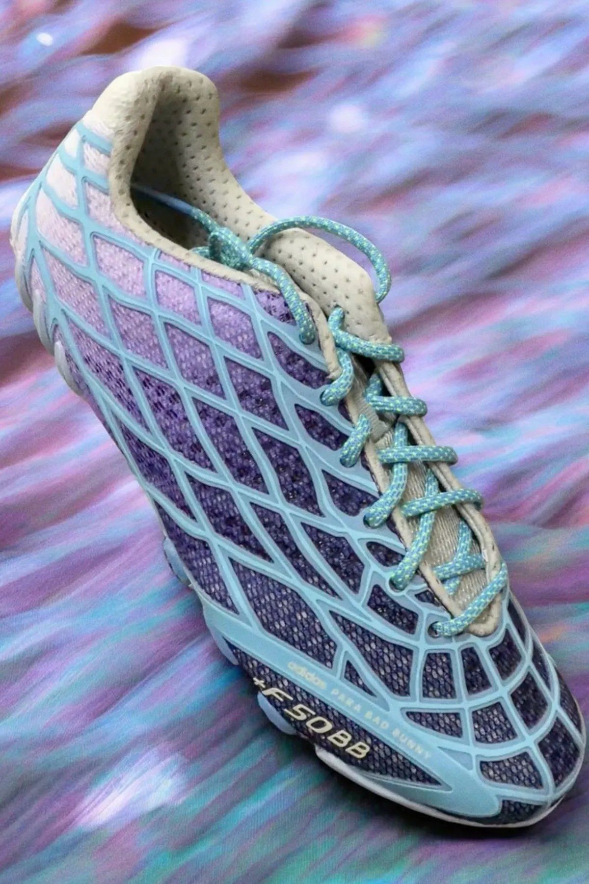 Bad Bunny x adidas F50 Ghost Sprint in purple and blue gradient colorway, showing F50 TPU skeletal upper paired with Ghost Sprint track outsole