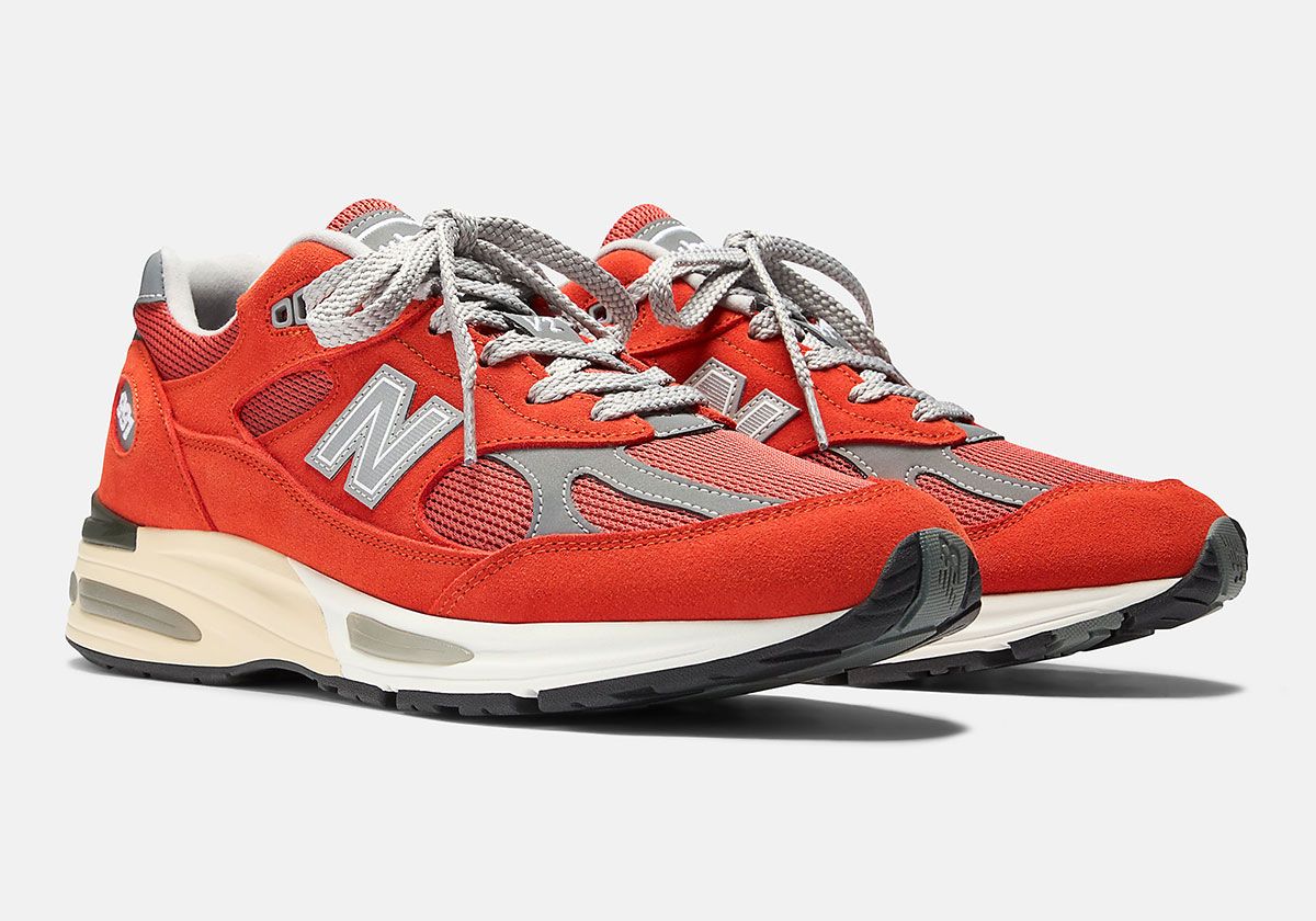 New Balance 991v2 in Grenadine colorway, featuring burnt orange suede upper with grey leather underlays and white sole unit