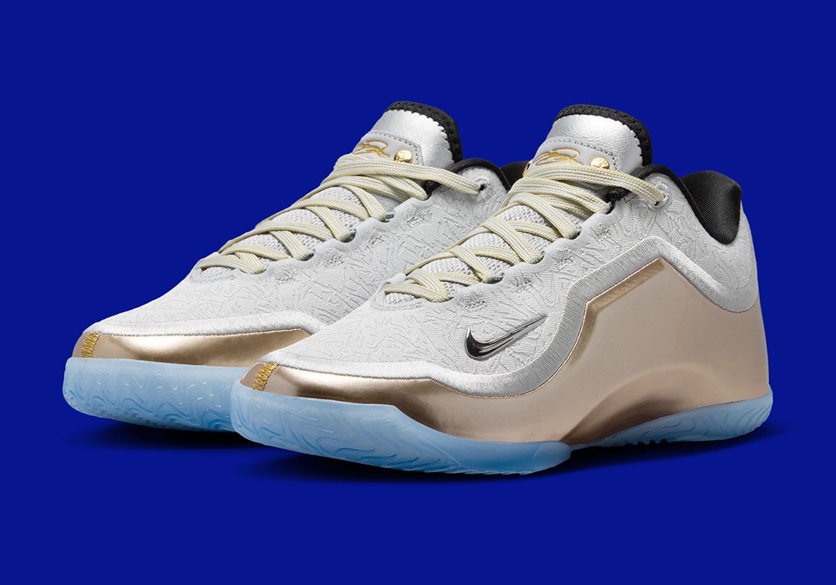Nike LeBron 23 Dreams And Nightmares with white upper, metallic gold accents, and championship ring graphic on heel
