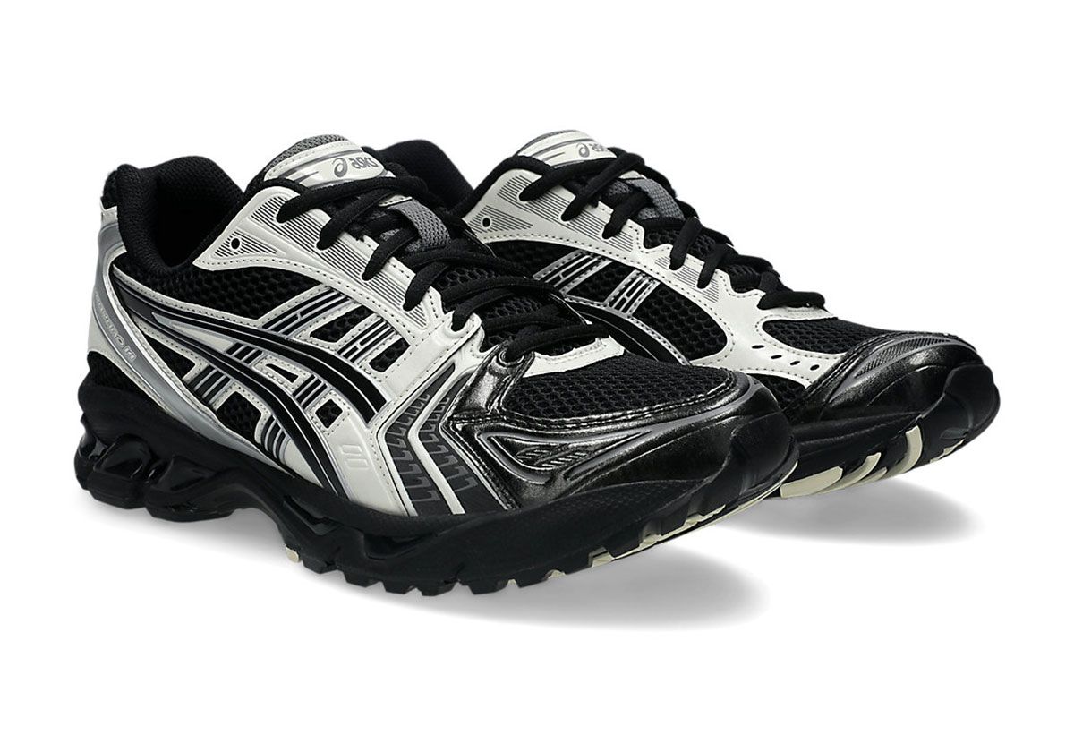 ASICS GEL-Kayano 14 in Black and Cream colorway, showing side profile with cream accents on quarter panel and metallic heel detail