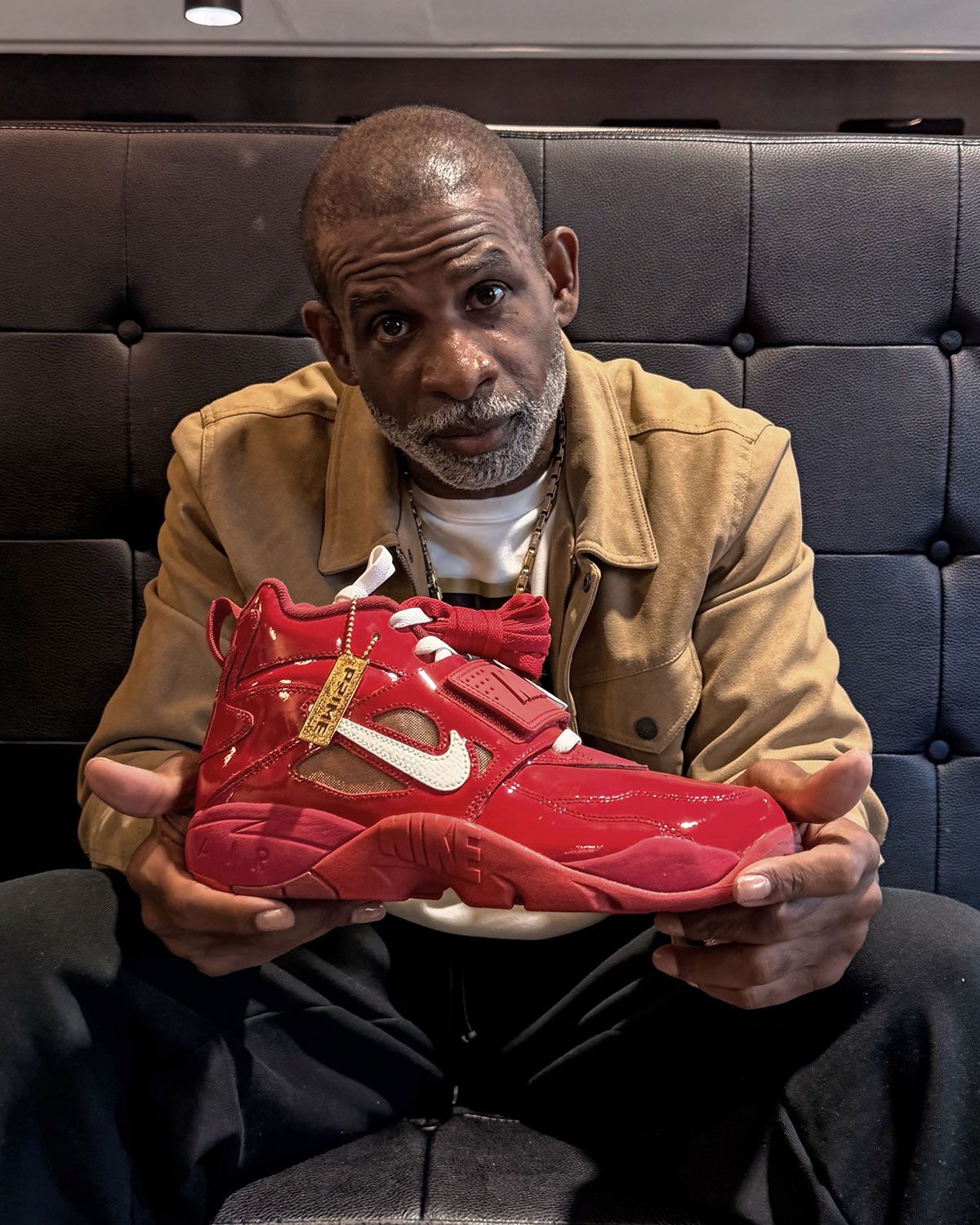 Nike Air DT Proto '92 Prime Red sneaker with glossy patent leather upper, Sail white accents, and Metallic Gold details
