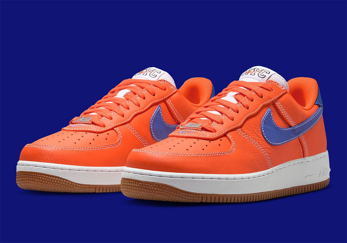 Nike Air Force 1 Low in Knicks colorway featuring Safety Orange leather, Rush Blue Swoosh, and Gum Medium Brown outsole