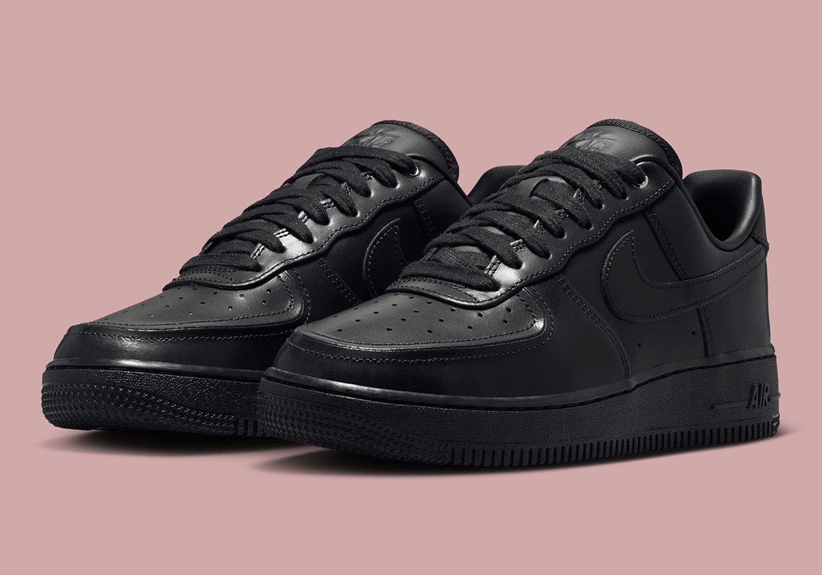 Nike Air Force 1 Low in Triple Black with debossed tongue branding and dimensional toe stitching