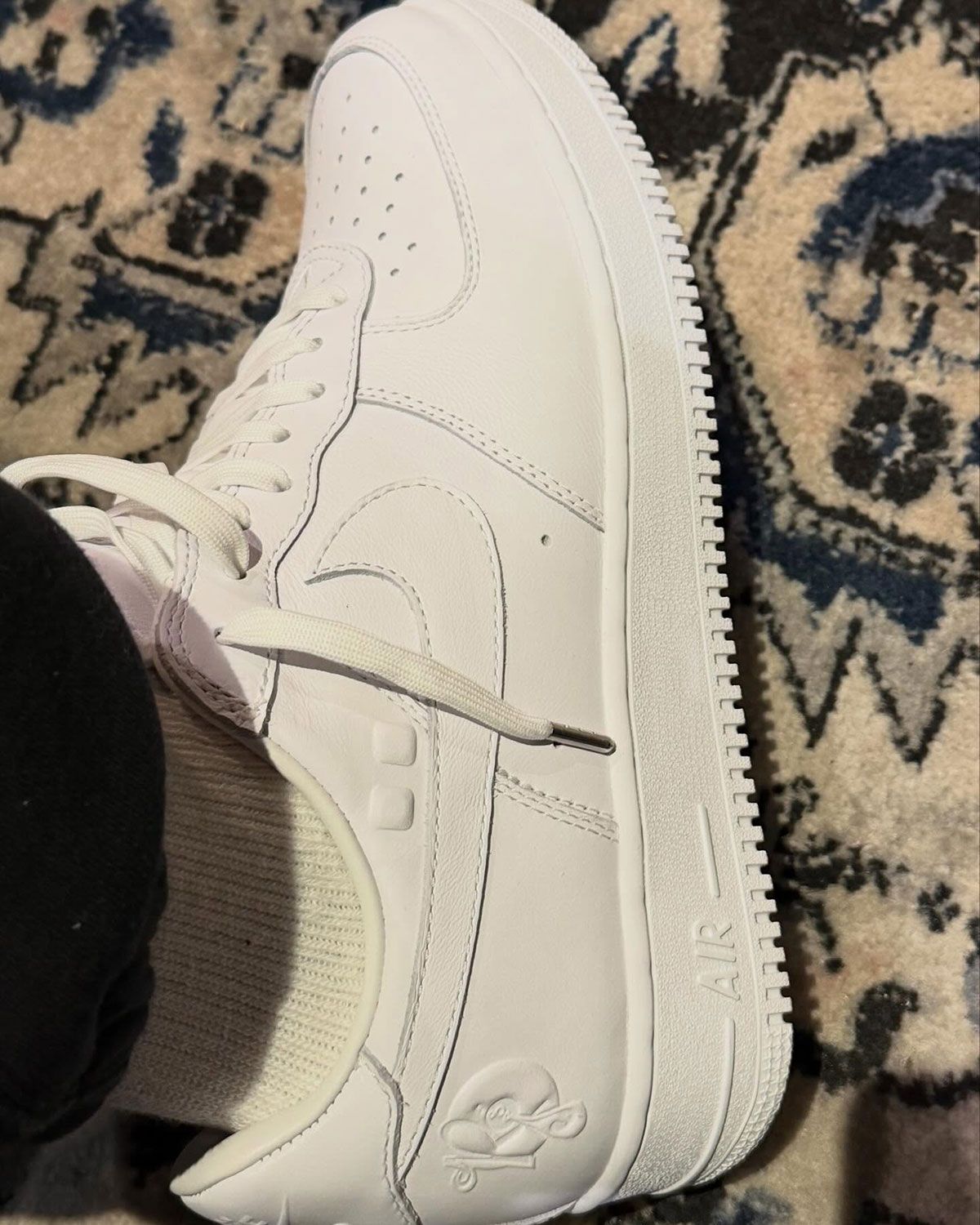 Nike Air Force 1 Low in white celebrating Jay-Z's Reasonable Doubt 30th anniversary with Roc-A-Fella Records branding on the heel