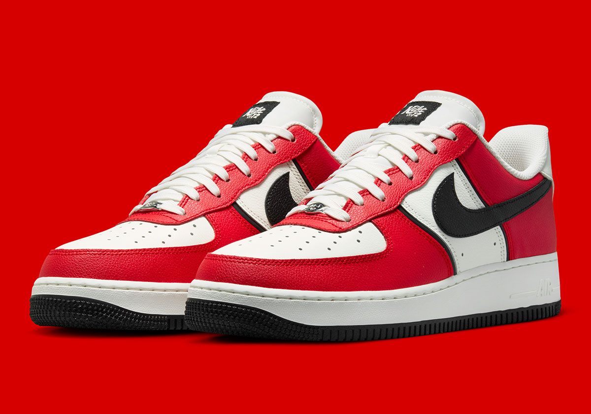 Nike Air Force 1 Low in University Red and black with diamond heel branding and Sail quarter panel