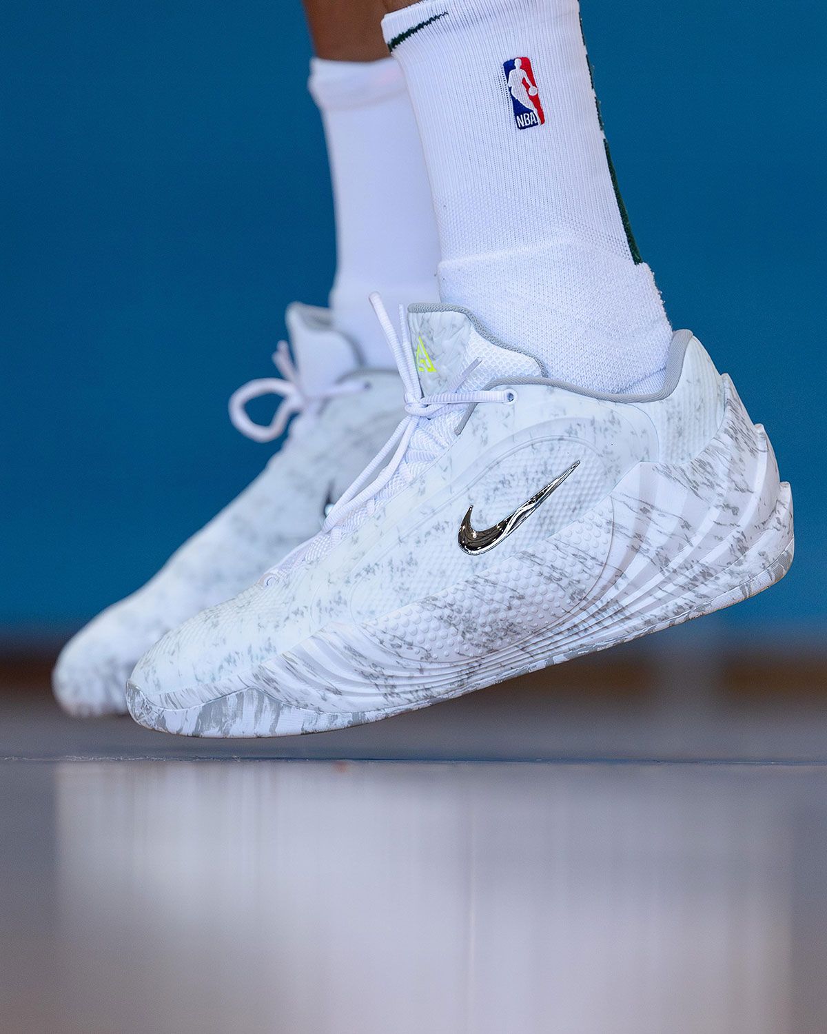Nike Giannis Freak 8 Wolf Grey with camo-print upper, chrome Swoosh, and Volt tongue branding