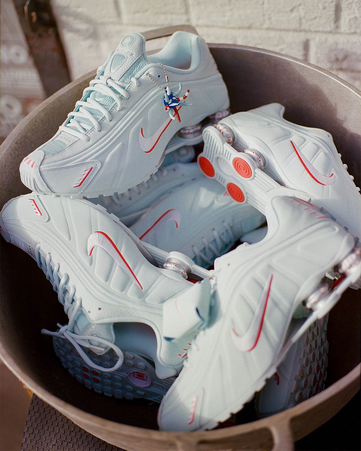 Nike Shox R4 Puerto Rico colorway featuring flag-inspired palette and Vejigante mask charm detail