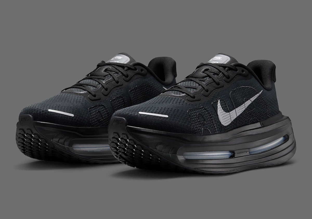 Nike Vomero Premium in Black/Off-Noir colorway, side profile view showing midsole stack and branding details
