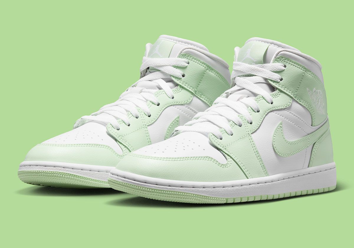 Nike Air Jordan 1 Mid in White/Volt Tint colorway, women's sizing, featuring white base with neon volt tint overlays
