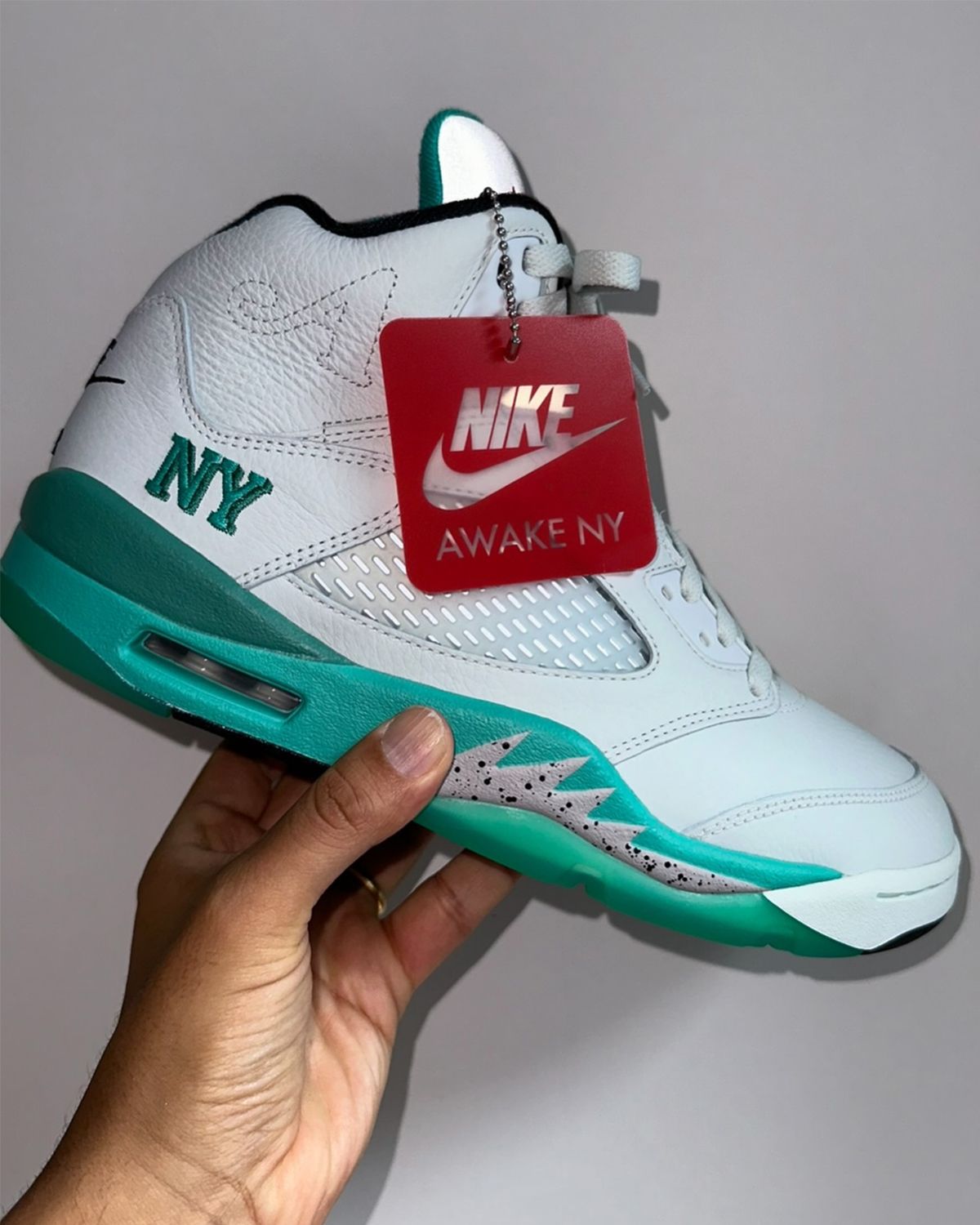 Unreleased Awake NY Air Jordan 5 sample in white leather with teal green midsole detail