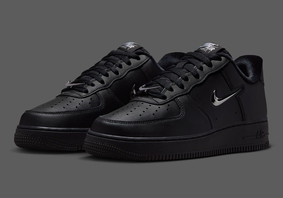 Nike Air Force 1 Low in black leather with chrome silver Swoosh detail, side view