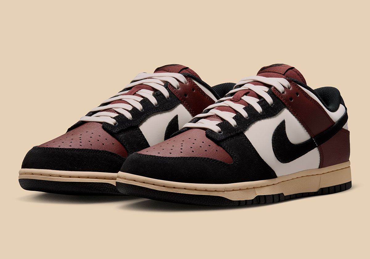 Nike Dunk Low 'Bronze Eclipse' showing pale ivory leather upper with bronze eclipse twill toe box and black suede accents