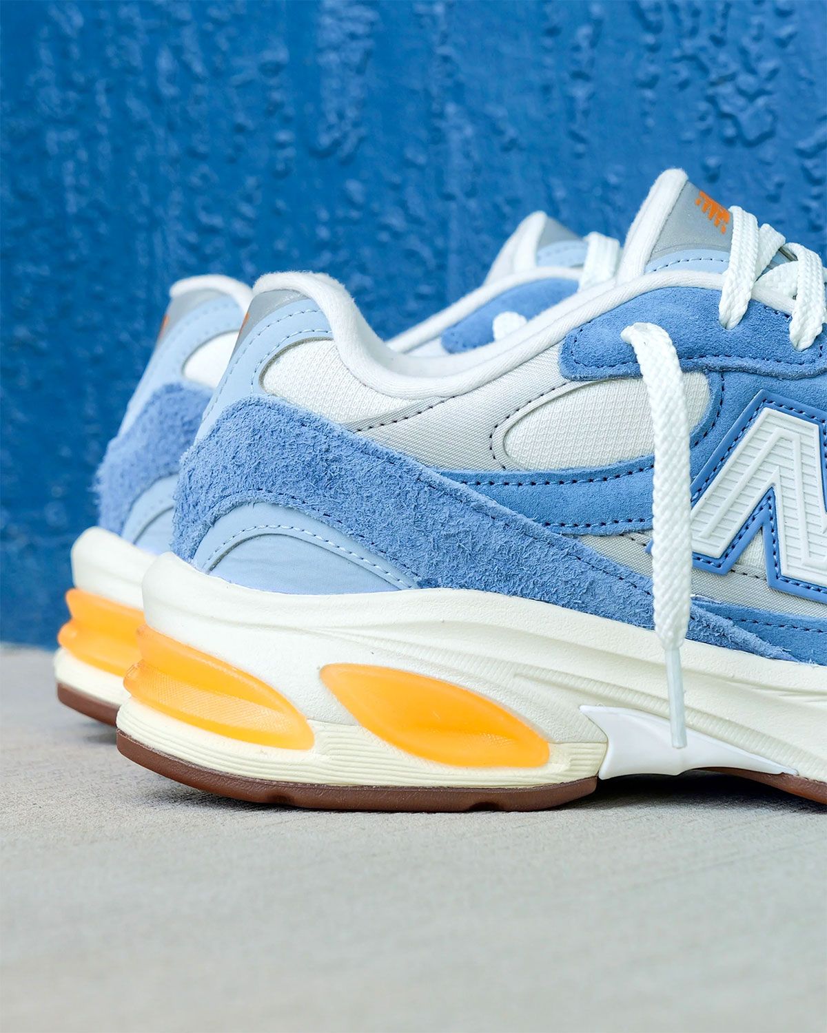 New Balance 2010 in Heron Blue suede with yellow ABZORB midsole, lateral and medial views