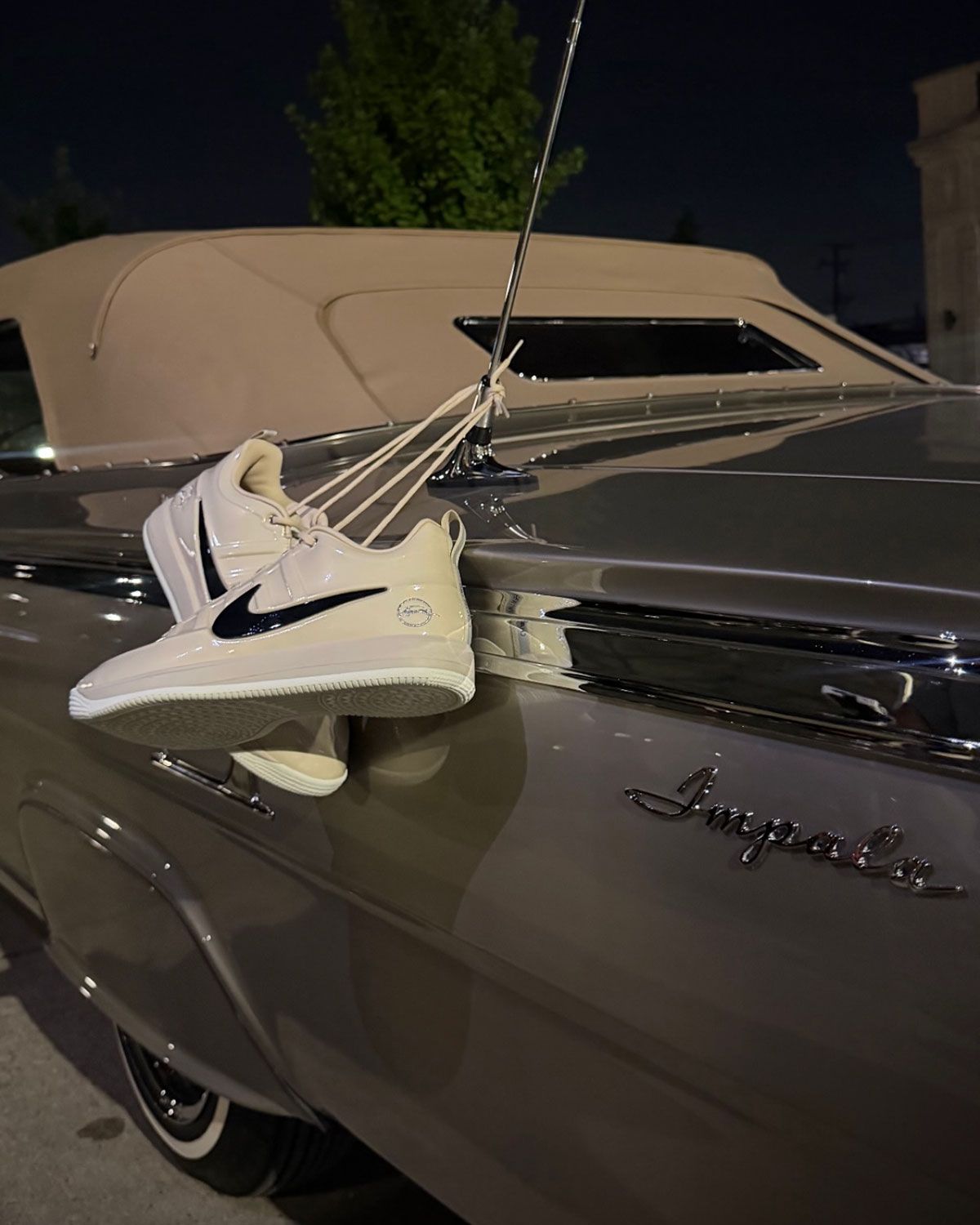Nike Book 2 Sand Drift colorway inspired by Devin Booker's 1962 Chevy Impala convertible, showing glossy molded upper and metallic silver heel emblem