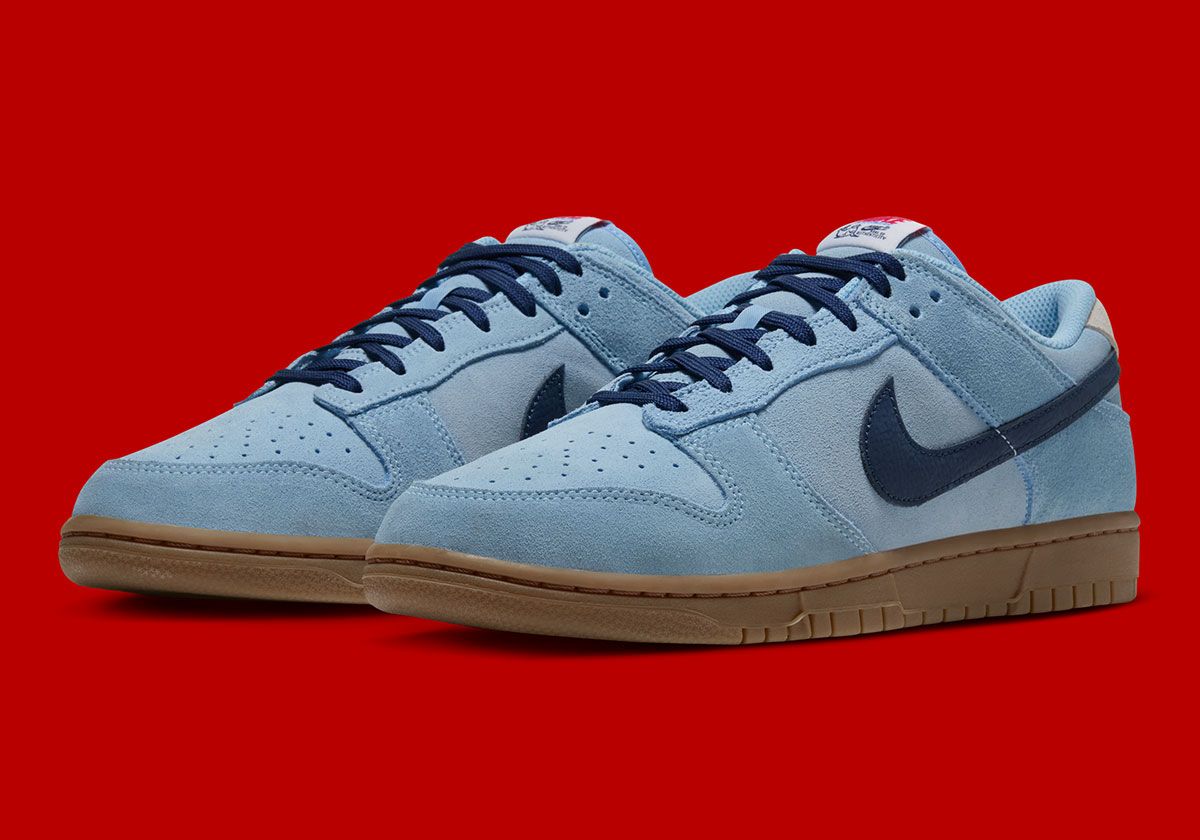 Nike Dunk Low 'Seal of Authenticity' in aquatic suede with white and red accents, featuring pinniped branding on insole