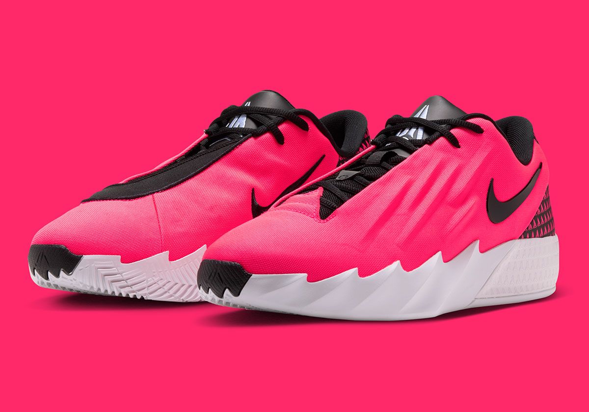 Nike Ja Twelve Time Atomic Pink basketball shoe showing mismatched lace stays spelling 'JA' and triangular logo on heel