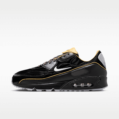Nike Air Max 90 Mercurial in Black/Gold Leaf/Pear/White colorway, showing visible Air Max cushioning and midfoot cage detail