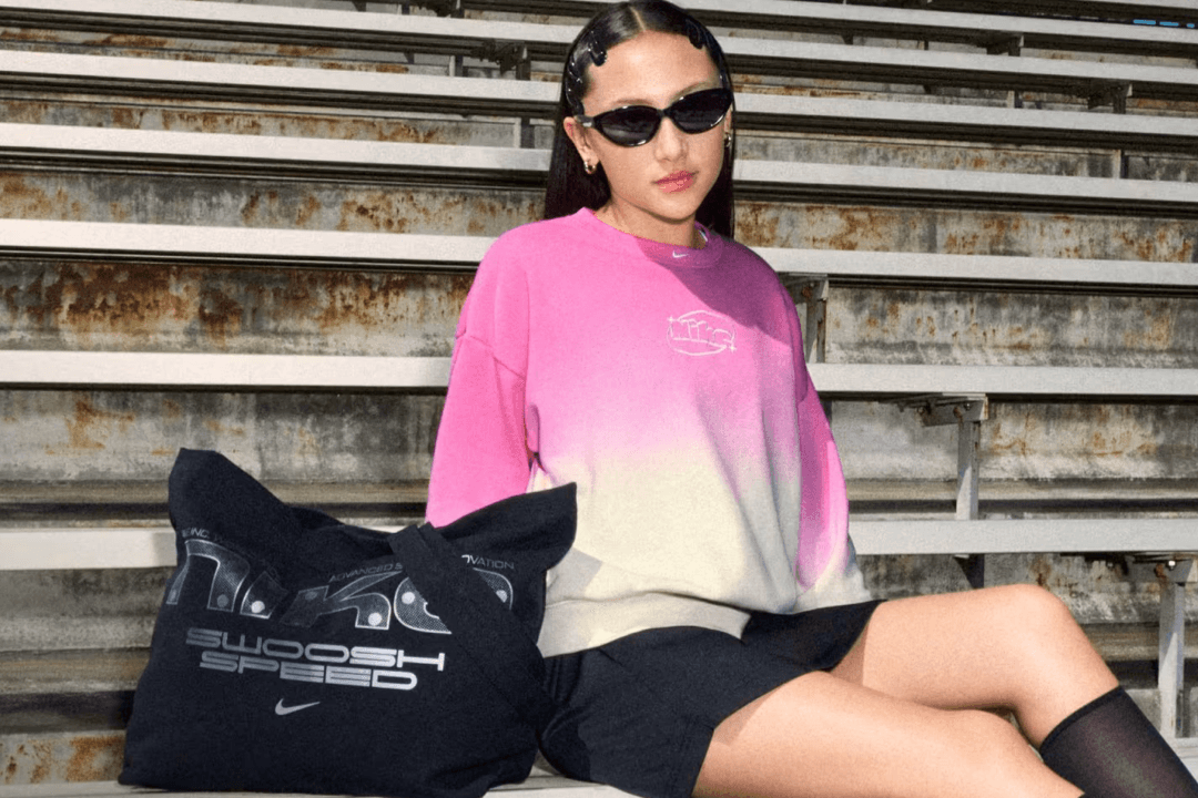 Nike Tech and Primary collection apparel laid flat, showcasing hoodies, joggers, and layering pieces in neutral colorways