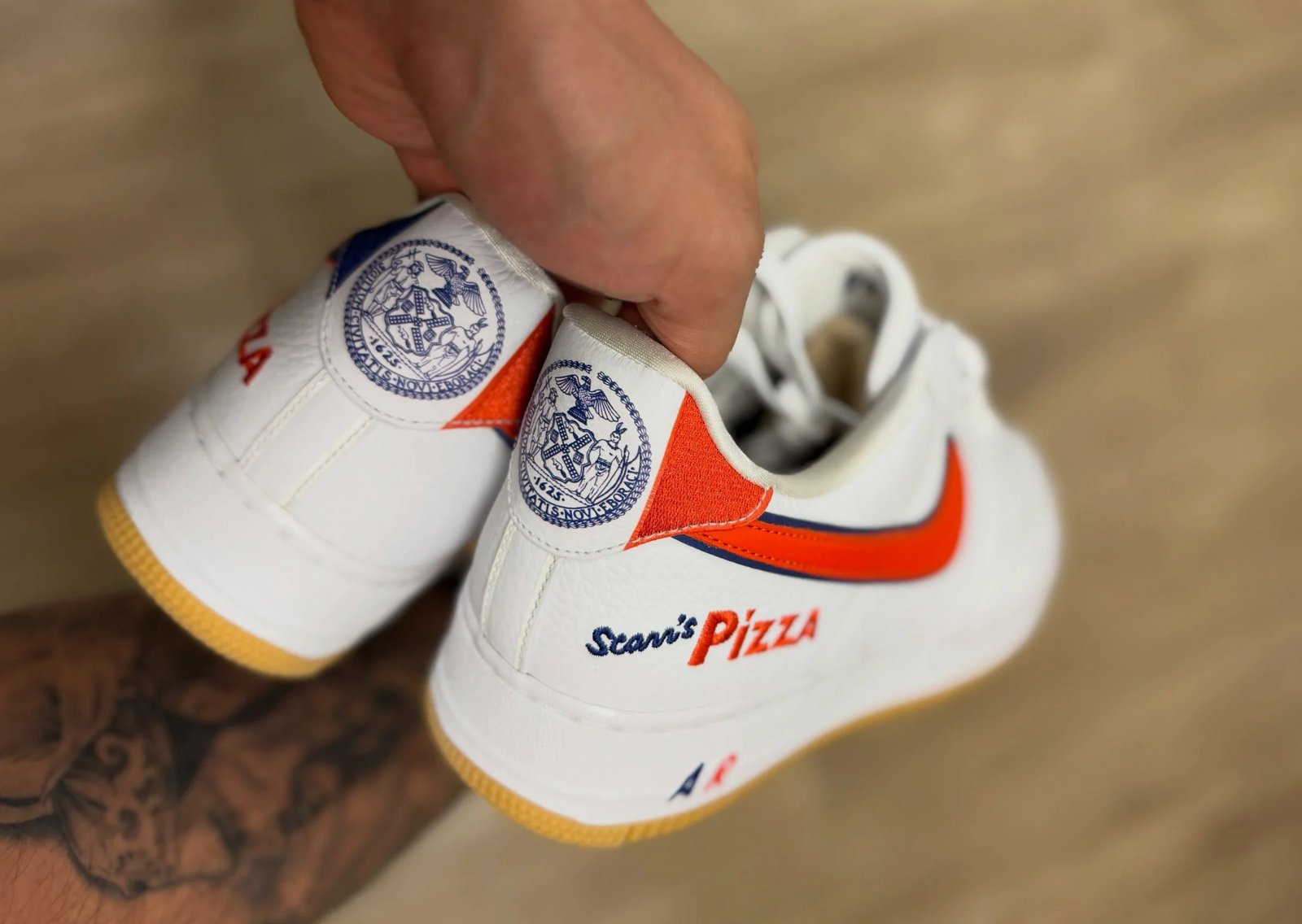 Nike Air Force 1 Low Scarr's Pizza 2025 sample featuring white leather upper with blue and orange Swoosh detailing and tan gum sole - detail view 2