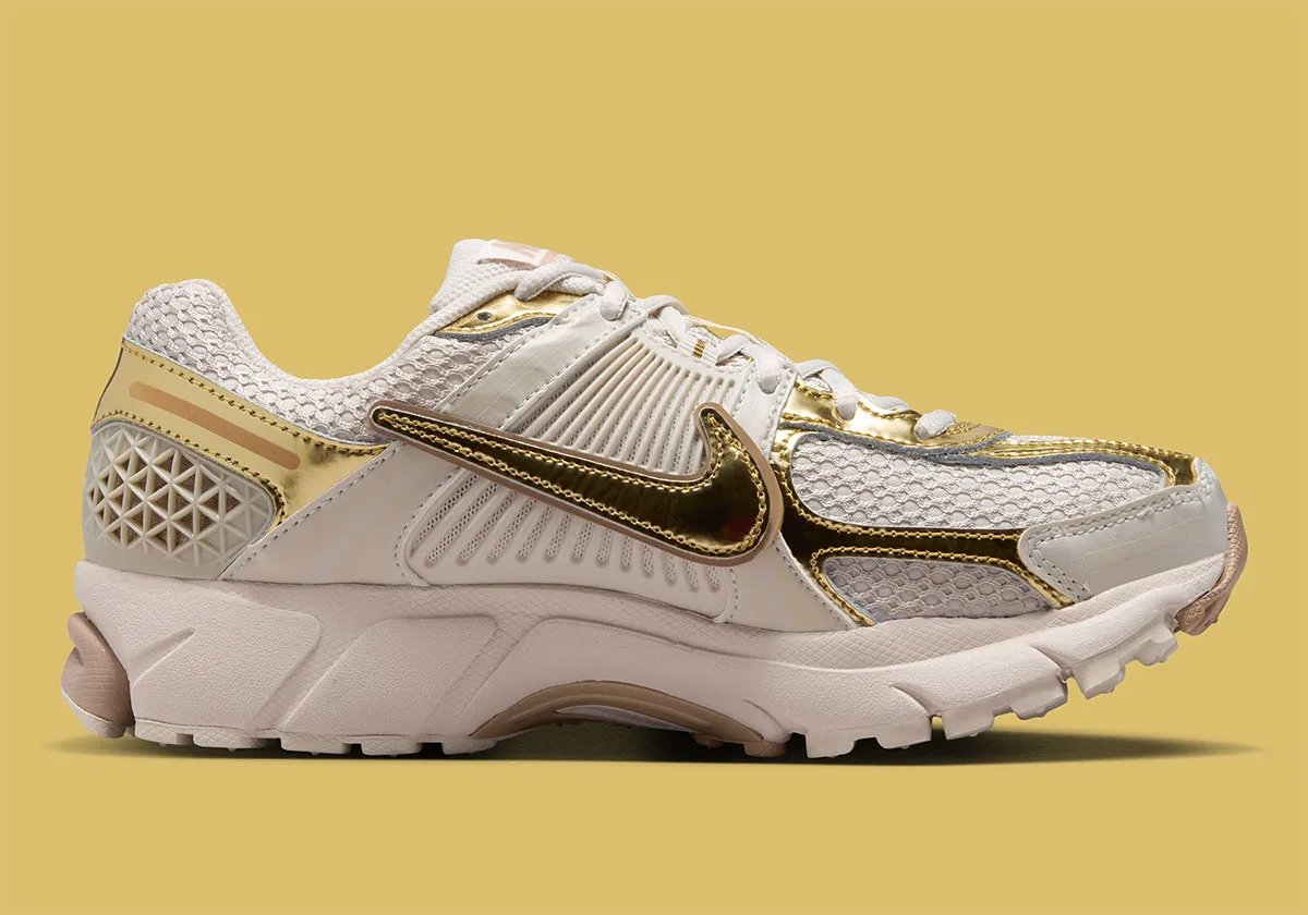 Nike Zoom Vomero 5 Metallic Gold colorway with rosy Swoosh detailing and metallic accents on upper - detail view 2